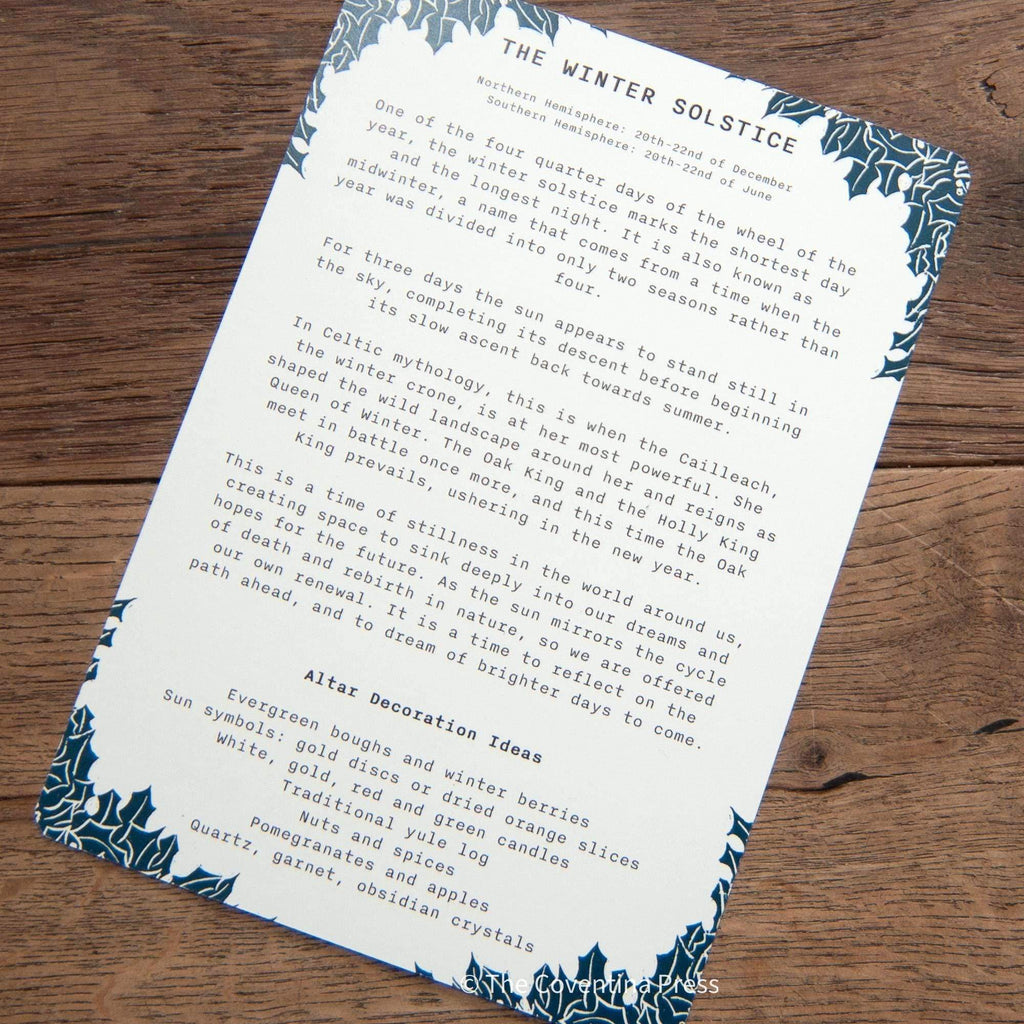 WINTER SOLSTICE altar card with a white text-covered reverse and dark blue botanical border on natural cardstock